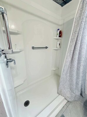 Shower, hair dryer, towels, shampoo