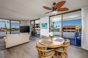Relax on the spacious balcony with a view of palm trees and a building, or unwind in the comfortable sofa.