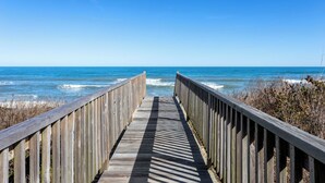 A wooden boardwalk leading to the ocean with a clear sky. - Just Fab * Oceanfront * Elevator * Saltwater Pool * Hot Tub * Game Room * Views (Nags Head)