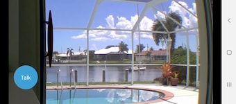 Pool house on a lagoon with sunset view