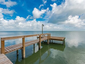 A wooden pier extending into calm waters, with a clear sky above. - Frisco Flats by Miss Kitty’s (Rockport)
