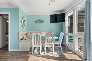 Enjoy a nautical-themed room with a dining area, comfortable bench, and large windows.
