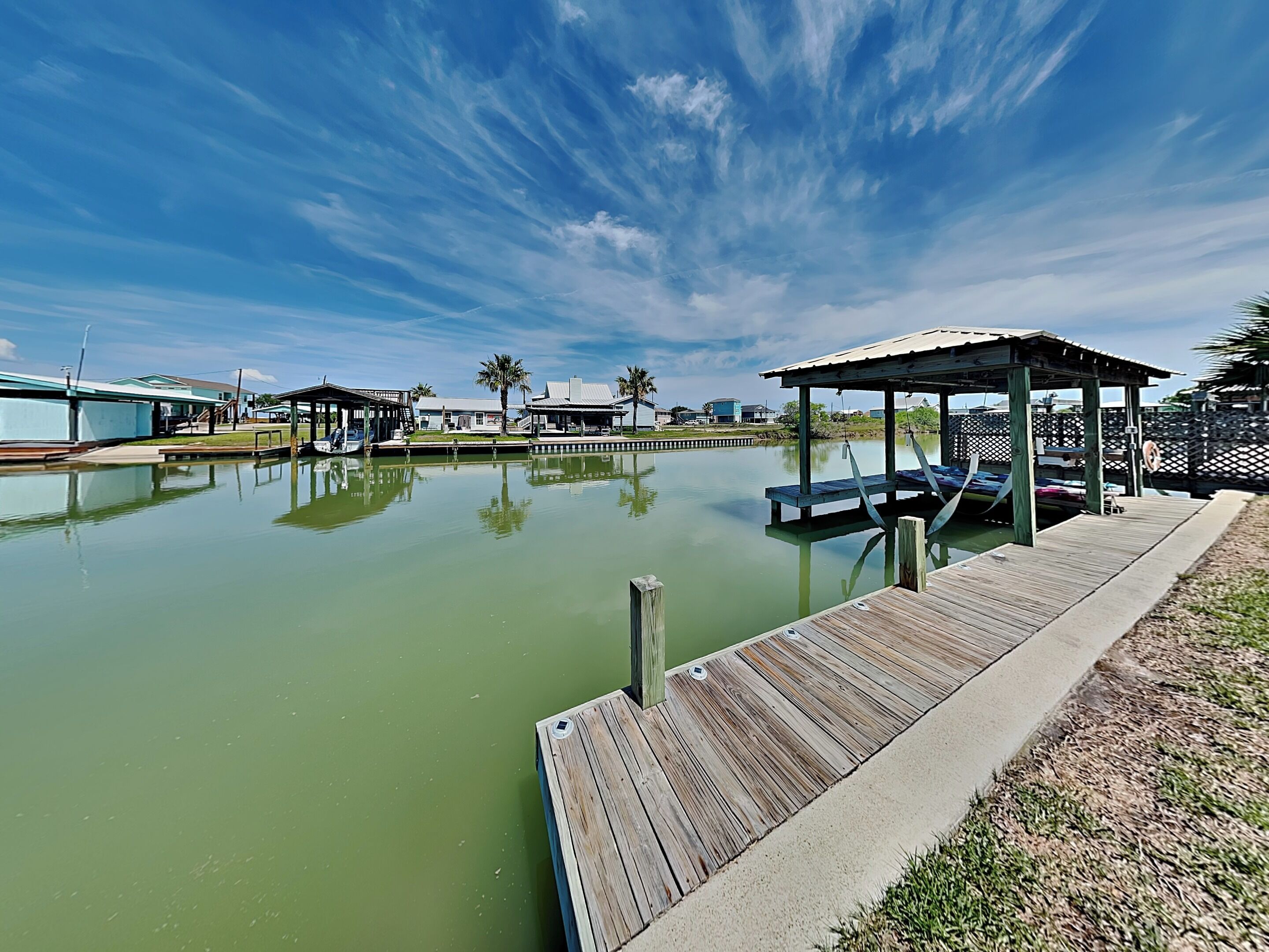 A calm water body with wooden docks and a gazebo.