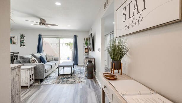 A modern living room with a sofa, coffee table, and a dining area. - The Perfect Tucson Townhome in Catalina Foothills (Tucson)