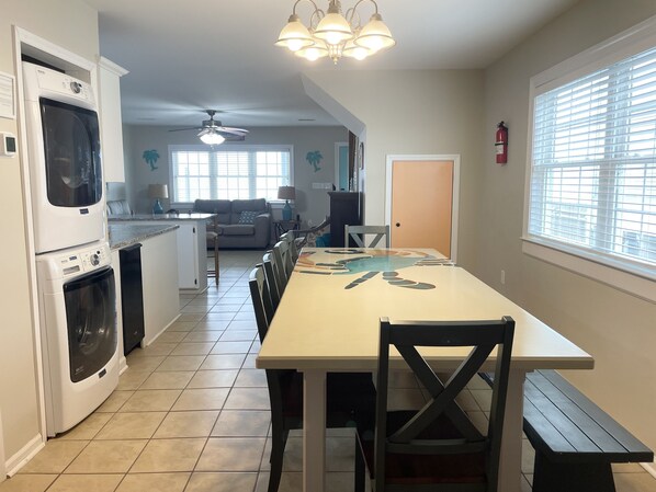 A kitchen with a dining table, chairs, and a built-in oven.