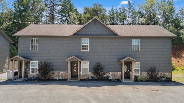 A two-story house with a stone foundation and a grey exterior. - Peaceful Getaway, Sleeps 6・Hot Tub (Sevierville)