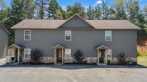 A two-story house with a stone foundation and a grey exterior. - Peaceful Getaway, Sleeps 6・Hot Tub (Sevierville)