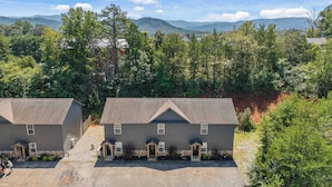 A two-story building with a symmetrical facade, a front entrance, and a driveway leading to a parking area. - Peaceful Getaway, Sleeps 6・Hot Tub (Sevierville)