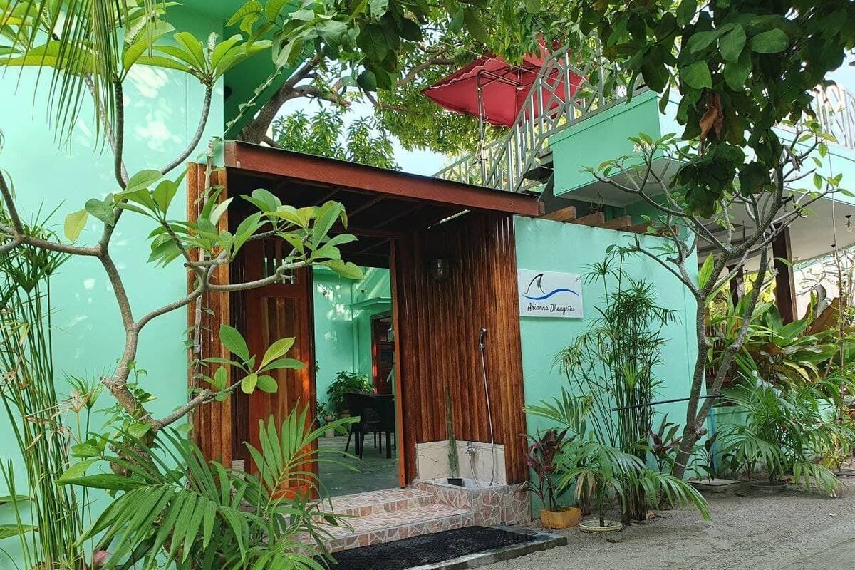 A small, single-story building with a wooden door and a small porch area.