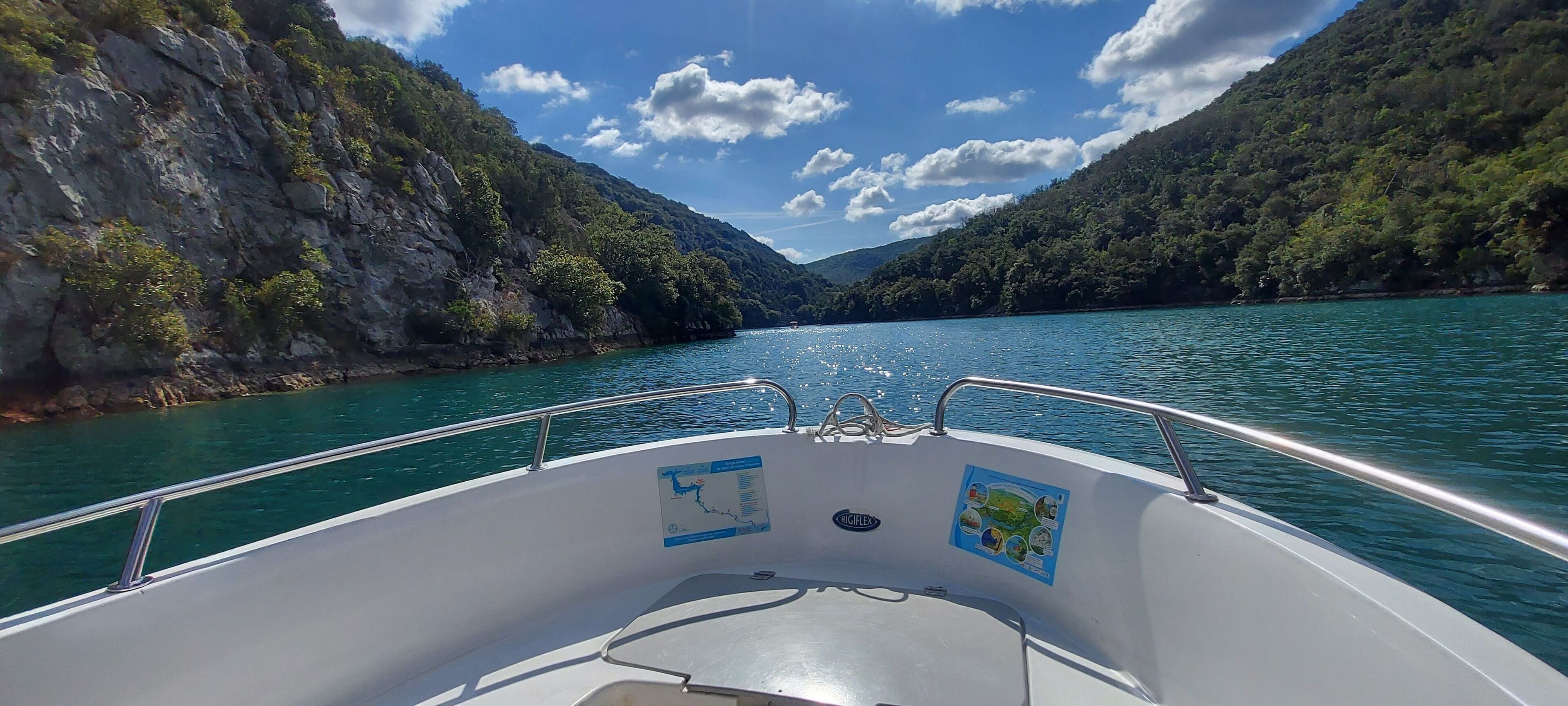 A boat's interior with a map and a metal railing.