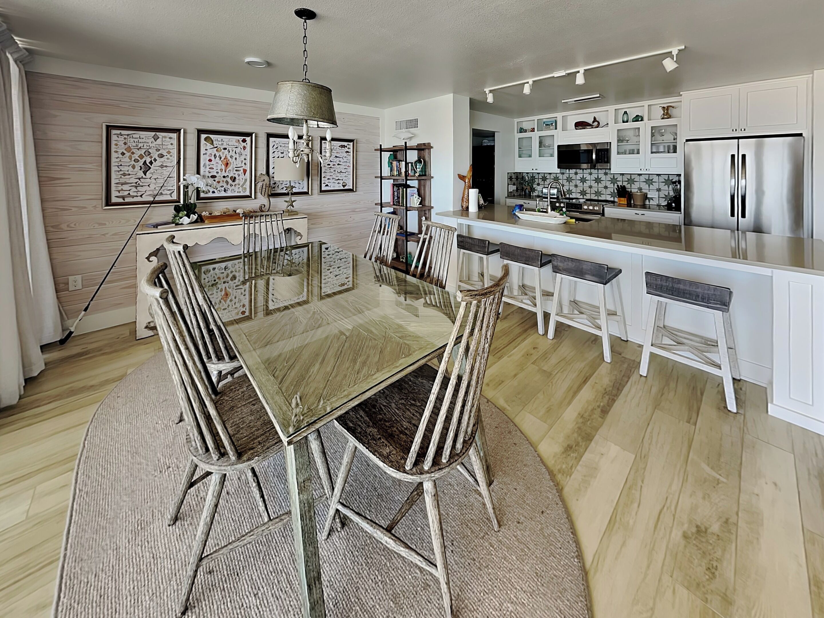 A modern kitchen with white cabinets, stainless steel appliances, and a central island.