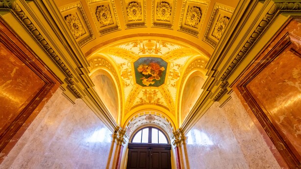 An ornate interior with a high ceiling, detailed frescoes, and a grand arched doorway. - Adagio Downtown Rooms (Budapest)