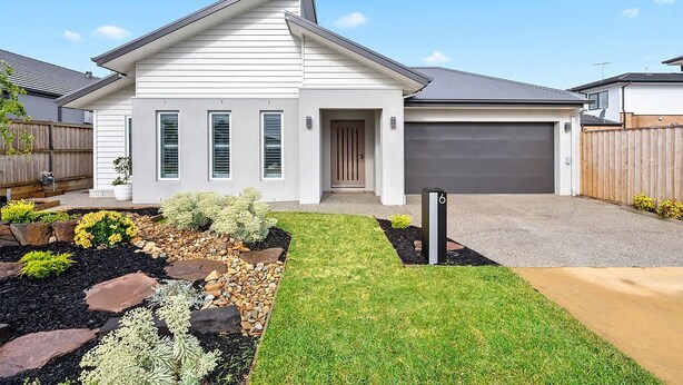 A modern single-story house with a garage, a well-maintained lawn, and a stone pathway leading to the entrance. - Luxury Large Home - LATE CHECK OUT Feb-Nov 2025 (Point Lonsdale)