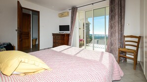 A bedroom with a bed, a wooden chair, a dresser, and a television. - Nice home in St Andrea Di Cotone (St Andrea Di Cotone)