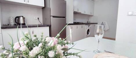 Fridge, stovetop, electric kettle, cookware/dishes/utensils