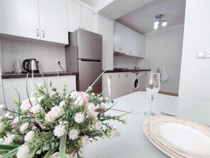 Fridge, stovetop, electric kettle, cookware/dishes/utensils