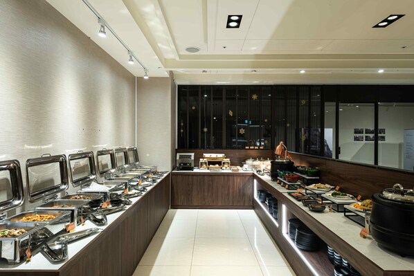 A buffet with multiple food stations, a coffee bar, and a counter with a coffee machine. - Spring's Rhapsody Hotel (Taichung)