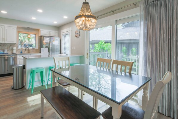 Enjoy meals in the kitchen with a central table and comfortable seating for all.