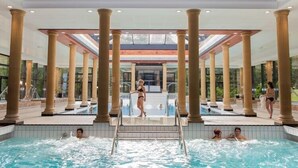 A large indoor swimming pool with columns and a mural on the ceiling. - Les Pins Sylvestres (Amneville)