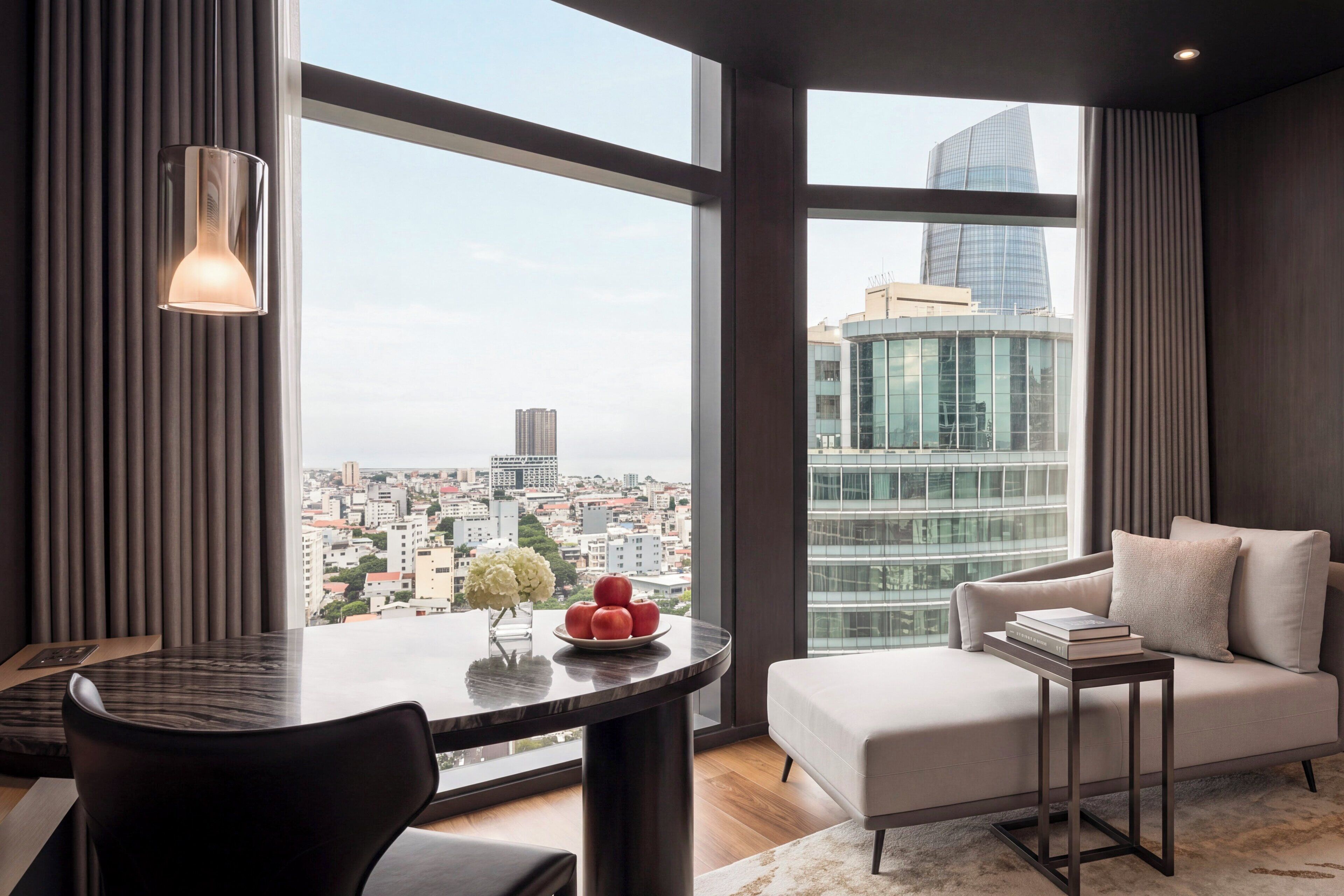 A modern living room with a city view, a round table, a sofa, and a small side table.
