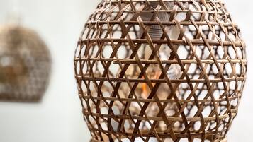 A wicker lamp with a spherical design and a woven pattern.