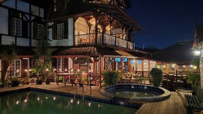A two-story building with a pool, outdoor seating, and a balcony. - Greenheart Boutique Hotel (Paramaribo)