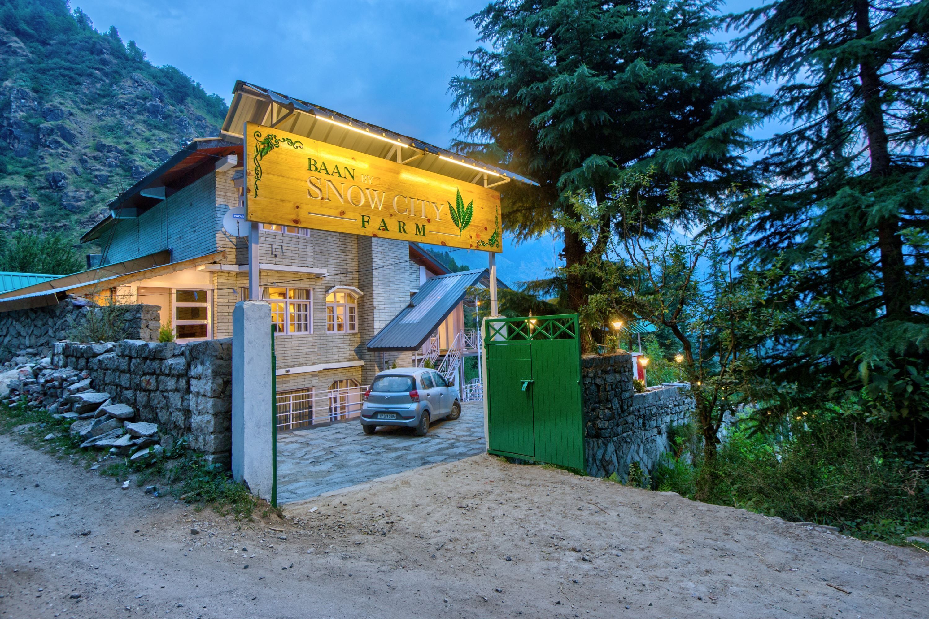 Un bâtiment agricole sur lequel est apposée une enseigne indiquant : « Baan Snow City Farm ».