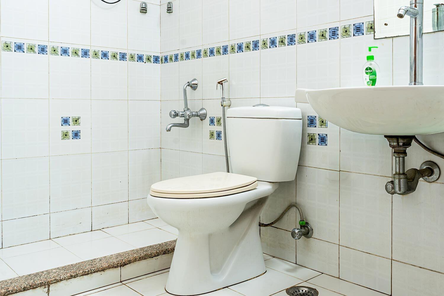 A bathroom with a toilet, a sink, and a shower.