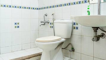 A bathroom with a toilet, a sink, and a shower.