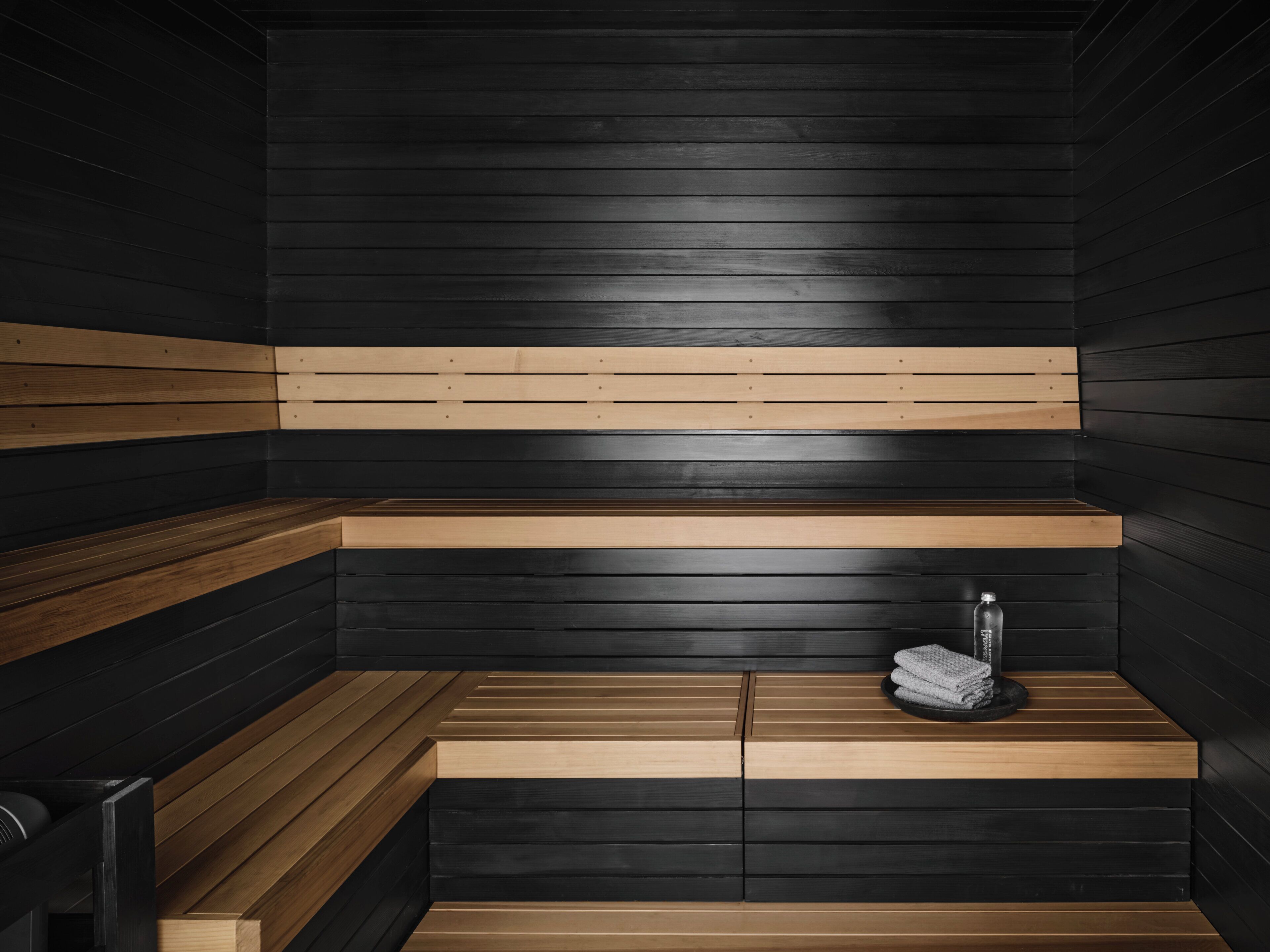 A sauna with wooden benches and a bench seat.