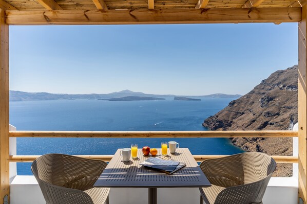 Uma mesa com vista para o mar e montanhas.