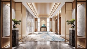 A modern hotel hallway with wooden paneling, a patterned carpet, and potted plants. - Ramada Encore by Wyndham Xishuangbanna Jinghong (Xishuangbanna Dai)