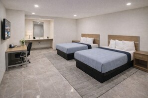 A hotel room with two beds, a desk, a chair, a mirror, and a TV. - Super 8 by Wyndham Bakersfield CA Near Airport (Bakersfield)