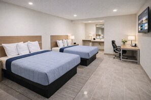 A hotel room with two beds, a desk, a chair, a mirror, and a TV. - Super 8 by Wyndham Bakersfield CA Near Airport (Bakersfield)