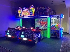 A gaming area with arcade machines and a claw machine.