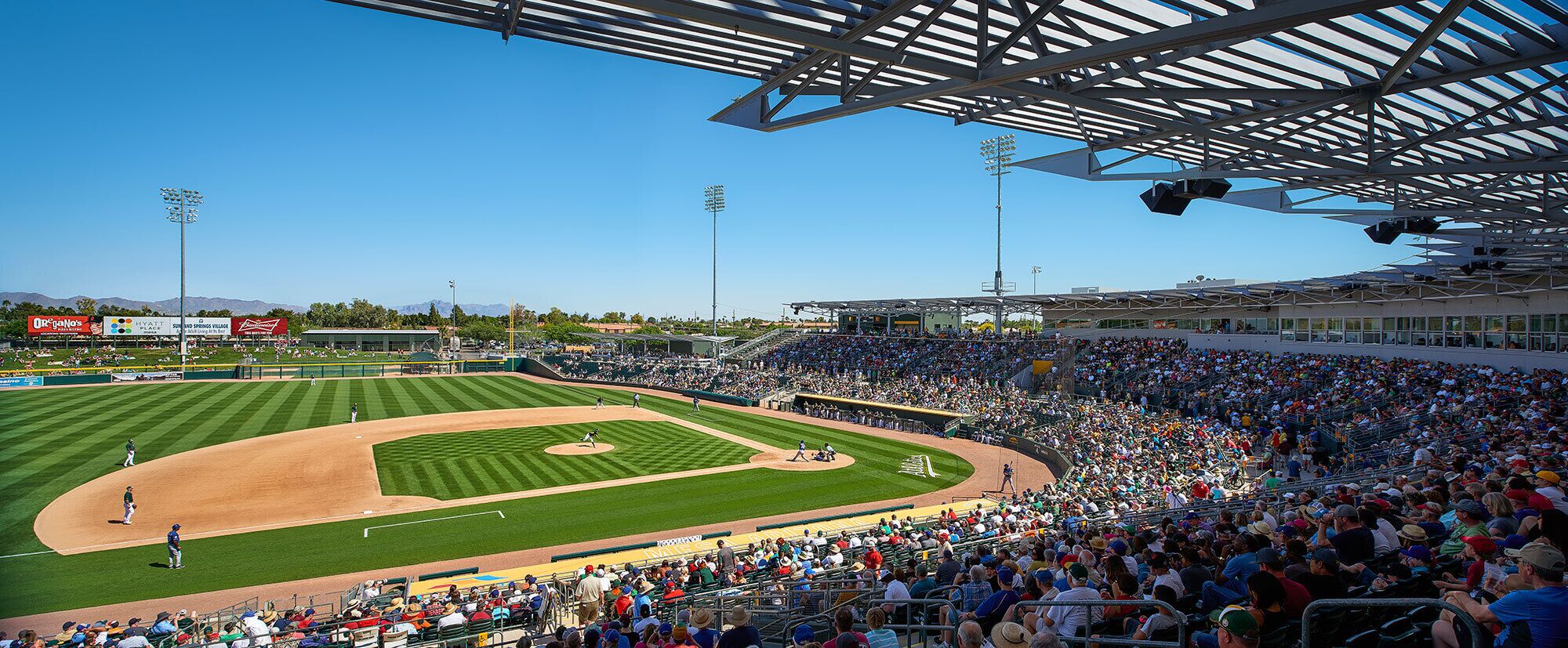 A baseball stadium with a large seating area and a well-maintained field.