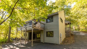 A two-story building with a balcony and a covered patio area.