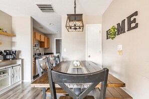 Enjoy meals in this dining area with a large table and comfortable chairs.