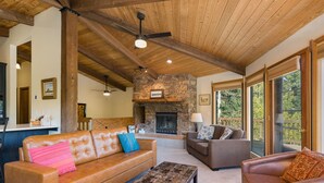 A spacious living room with a stone fireplace, leather sofas, and a wooden ceiling. - Cabin on Columbine Lake - Large deck - Hot Tub/Views  - 1 mile to Purgatory (Durango)
