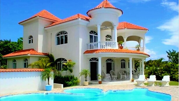 Una casa grande de varios pisos con una piscina delantera.
