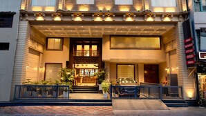 A hotel with a classic facade, large windows, and a prominent entrance. - Country Inn Hall Of Heritage Amritsar (Amritsar)