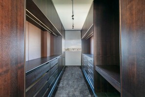 A narrow hallway with dark wood paneling and a gray carpet. - Luxury 1 Bedroom Apt with Harbour Views & Parking (Sydney)