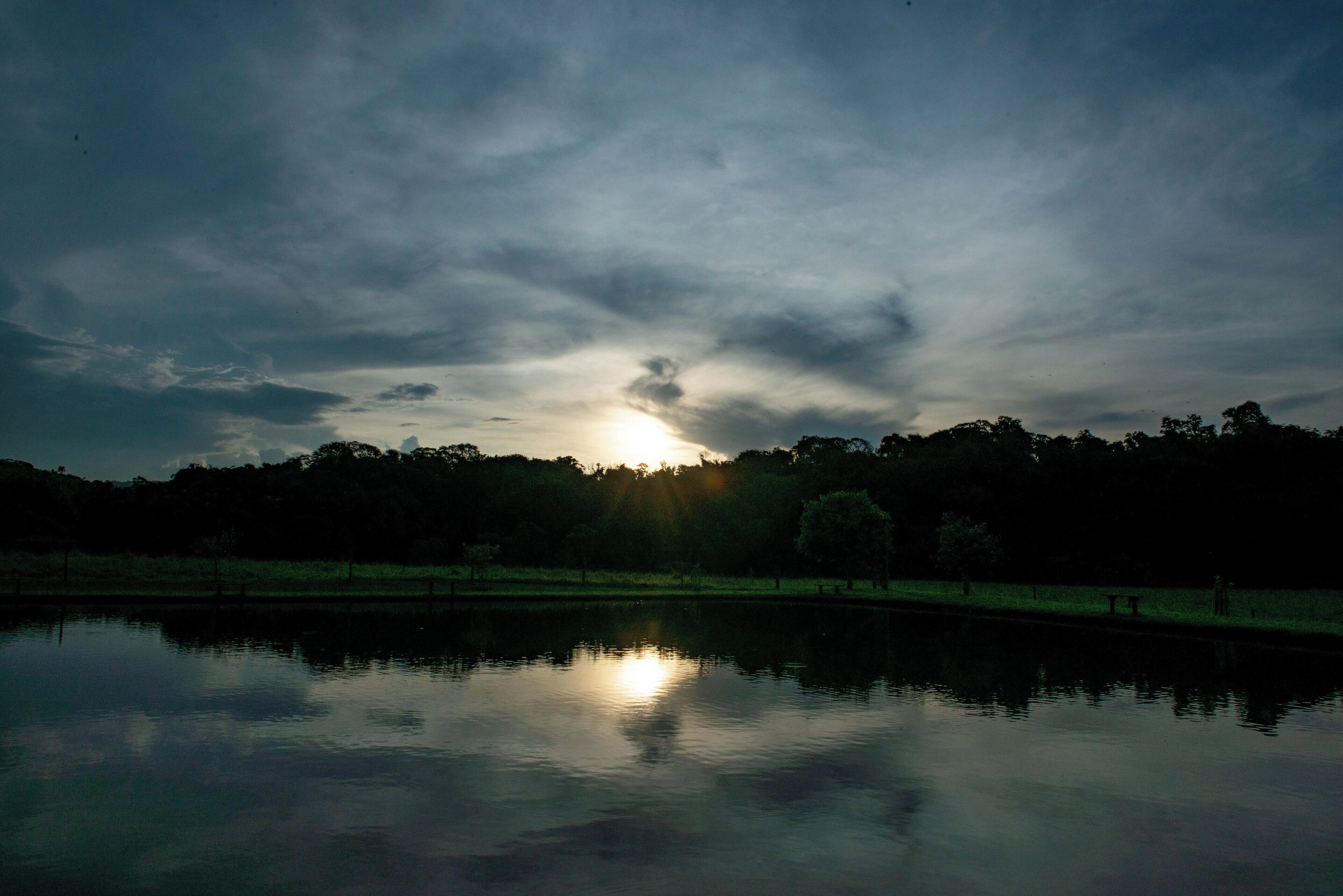 A calm body of water reflecting the sky.