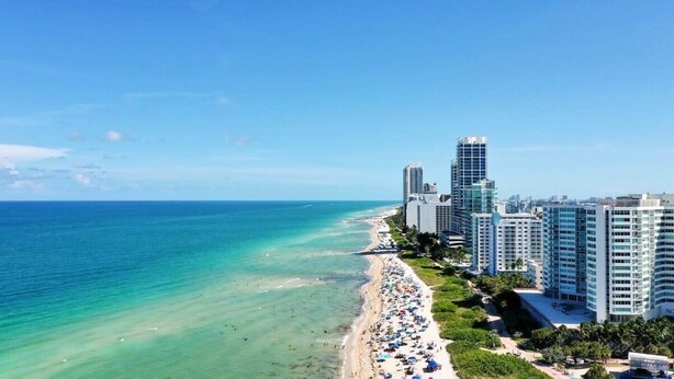 A coastal cityscape with a beach, high-rise buildings, and a clear sky. - Beach Bae, Bright Studio, Steps to the Ocean (Miami Beach)