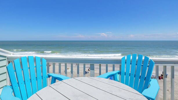 A beach view with two blue Adirondack chairs and a wooden table. - Seaside Vista, Luxury Oceanfront, Top "2nd" Floor, Amazing Views!! (Kure Beach)
