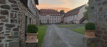 Quiet vacation apartment with wood-burning stove, sauna, garden & terrace on historic estate. Castle courtyard