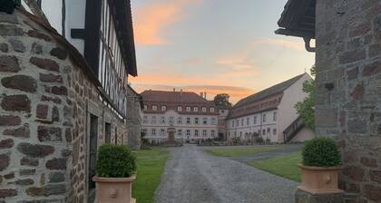 Quiet vacation apartment with wood-burning stove, sauna, garden & terrace on historic estate. Castle courtyard