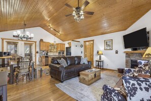 Relax in this inviting living area with a comfortable sofa, armchair, and fireplace.