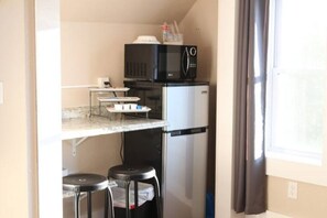 Fridge, microwave, coffee/tea maker, cookware/dishes/utensils