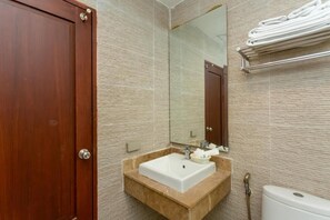 Standard bathroom with a sink, mirror, and towel rack.